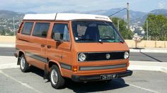 an orange van parked in a parking lot