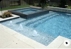 an empty swimming pool with water spouting from the bottom and two fountains in the middle