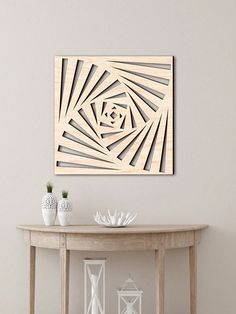 a table with some vases on it next to a white wall and a painting