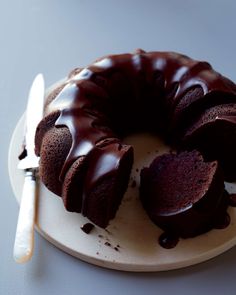 a chocolate bundt cake on a plate with a knife