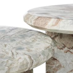 two marble tables sitting next to each other