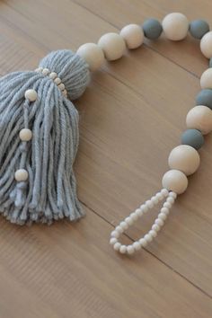 a tasseled beaded necklace on a wooden floor