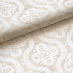 a white and beige wallpaper with an ornate design on it's surface,