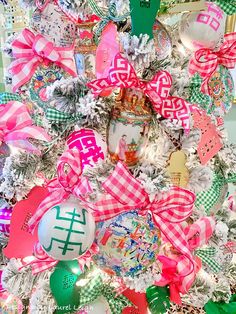 a christmas tree decorated with pink, green and white ornaments