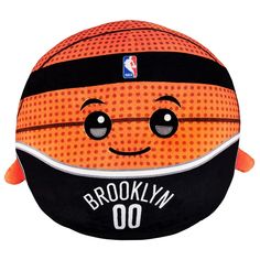 an orange and black basketball with the brooklyn nets on it's face is sitting in front of a white background