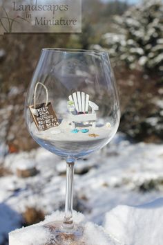 a wine glass filled with snow and sand