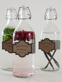 three glass bottles filled with different types of drinks