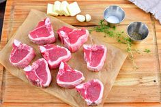 raw meat on a cutting board with garlic and seasoning