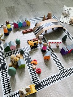 toy train tracks and wooden toys on the floor