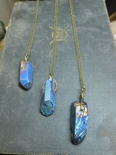 "An absolutely stunning cobalt blue titanium coated rough raw Quartz sits as a lonesome dove wrapped in rustic brass wire and is suspended from a rustic brass chain. Please make chain length choice at checkout. Enjoy! each one is made to order- expect slight variations in your crystal. Crystal will be approx 1.25\"- 1.5\" in length I hope you enjoy my handmade creations, or that special vintage notion you found in my shop! x and o , Chymiera" Mystical Blue Pendant Necklace, Blue Raw Stone Spiritual Jewelry, Spiritual Blue Raw Stone Jewelry, Adjustable Blue Raw Stone Jewelry, Adjustable Raw Blue Stone Jewelry, Adjustable Blue Jewelry With Raw Stone, Magical Blue Pendant Jewelry, Unique Blue Raw Stone Jewelry, Unique Blue Jewelry With Raw Stone