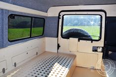 the inside of a camper with an open door and window on it's side