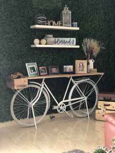 there is a bike that is sitting on the floor in front of a shelf with pictures