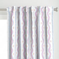 a white curtain with blue and pink stripes