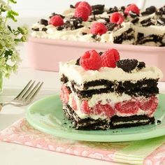 a piece of cake on a plate with raspberries