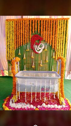 a decorated bed with flowers and candles on the side is shown in front of a green wall