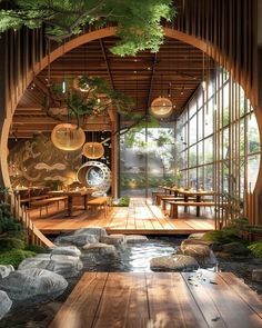 the inside of a restaurant with wooden floors and large windows, surrounded by greenery