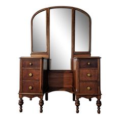 an antique wooden vanity with mirror and two drawers on it's legs, against a white background