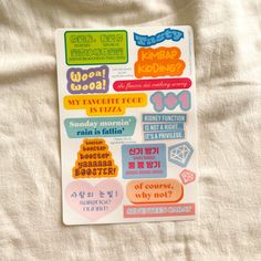 a sheet of stickers with words and phrases on white sheets that include korean characters