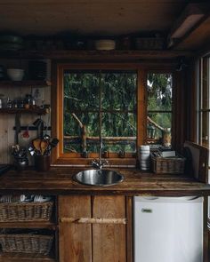 a kitchen area with a sink, dishwasher and window