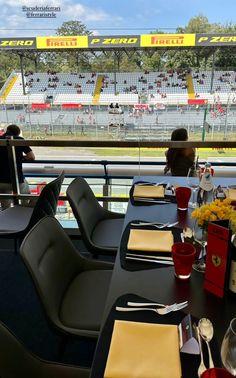 the race track is empty and ready for people to sit at their tables in front of them