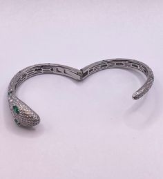 Step into a world of vintage elegance with our stunning snake serpent bangle cuff bracelet. 🐍 Crafted with 925 sterling silver and adorned with sparkling cubic zirconia, this piece is a true showstopper. Its intricate design and timeless beauty make it the perfect addition to any jewelry collection. Don't miss out on our sale and get your hands on this exquisite vintage piece today. #VintageJewelry #ElegantDesign #TimelessBeauty #JewelrySale #TomWayneJewelers Silver Bangle With Pave Setting As Gift, White Gold Snake Jewelry For Formal Occasions, Elegant Snake-shaped Jewelry For Anniversary, Elegant Snake-shaped Jewelry For Formal Occasions, Elegant Snake-shaped Bangle As Gift, Luxury Flexible Silver Bangle, Elegant Silver Snake Shape Bracelet, Elegant Snake-shaped Jewelry With Diamond Accents, Silver Snake-shaped Bracelet For Parties