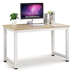 a computer monitor sitting on top of a wooden desk