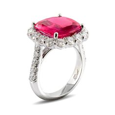 This is a beautiful platinum ring featuring a cushion cut pink sapphire surrounded by diamonds. Round brilliant diamonds encircle the cushion cut pink sapphire in a platinum bezel setting. Also, pink sapphire, carat total weight 7.25, round brilliant diamonds, carat total weight 2.06cts. Pink sapphires are given for the 5th, 23rd, and 45th wedding anniversaries, and often gifted on the 65th anniversary. This wedding & engagement ring will cherish your wife as her ring as well as pass it down for Cushion Cut Ruby Ring With Diamond Accent Stones, Cushion Cut Ruby Wedding Ring, Pink Cushion Cut Diamond Ring For Wedding, Pink Cushion Cut Ring With Prong Setting, Formal Pink Cushion Cut Ring, Pink Cushion Cut Diamond Ring With Prong Setting, Pink Cushion Cut Brilliant Ring, Formal Pink Sapphire Rings With Cushion Cut, Luxury Pink Sapphire Ring With Round Cut