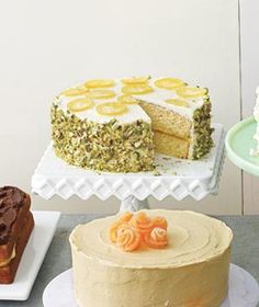 a table topped with cakes and desserts covered in frosting