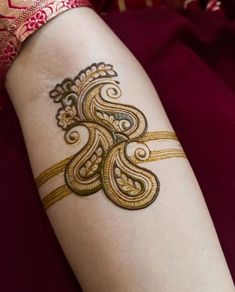 a woman's arm with a henna tattoo on it