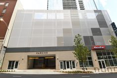 an empty parking garage in front of a tall building