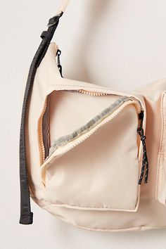 the inside of a white purse with zippers on it's sides and an open pocket