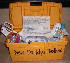 the new daddy's toolbox is filled with personal care items for his son