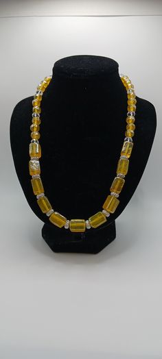 Ladies necklace with rectangle yellow glass beads and round yellow beads and round crystals.  Elastic Gold Beaded Glass Crystal Necklaces, Yellow Beaded Necklaces With Faceted Beads For Gift, Yellow Faceted Beads Necklace As Gift, Yellow Faceted Beads Necklace For Gift, Party Jewelry With Large Yellow Beads, Yellow Single Strand Beads For Gifts, Elegant Yellow Party Beads, Yellow Single Strand Beads For Jewelry Making, Vintage Yellow Necklace With Colorful Beads