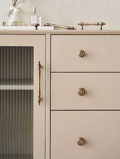 a white dresser with drawers and two faucets on it's top shelf