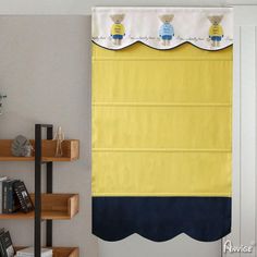 a yellow and blue curtain hanging on the side of a wall next to a bookshelf