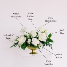 a vase filled with white flowers on top of a table