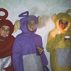 three people in animal costumes standing next to each other holding drinks and looking at the camera