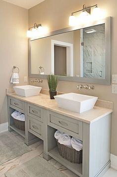 a large bathroom with two sinks and mirrors