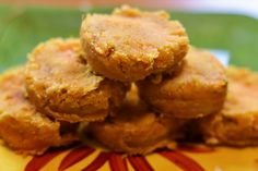 some fried food is stacked on top of each other in a yellow and red plate