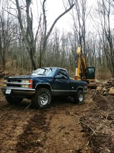 a truck is parked in the mud near a construction site