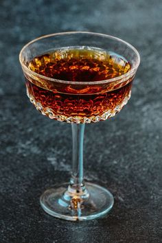 a glass filled with liquid sitting on top of a table