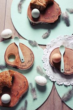 three plates with eggs and pastries on them sitting on a wooden table next to each other