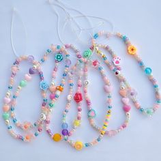 several necklaces with different colored beads on them