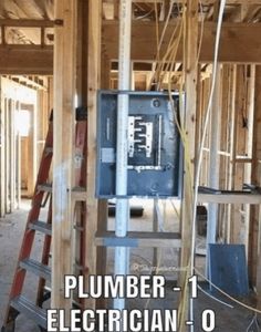 an electrical panel in the middle of a house being built with wood framing around it