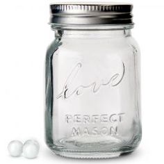 an empty mason jar with two white balls