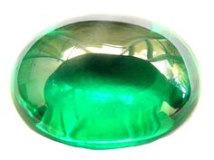 a green glass object sitting on top of a table