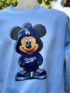 Mickey Dodgers inspired sweater design. DTF enhanced and vibrant colors. Long Sleeve Sweatshirt For Baseball Season Streetwear, Retro Blue Hoodie For Fall, Blue Retro Hoodie For Fall, Blue Casual Sweatshirt With Character Print, Sporty Winter Sweatshirt With Character Print, Casual Blue Sweatshirt With Character Print, Blue Varsity Sweater For Streetwear, Blue Varsity Sweater With Ribbed Cuffs, Game Day Crew Sweater For Winter