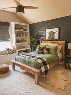 a bed room with a neatly made bed next to a book shelf filled with books