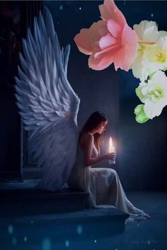 a woman sitting on the ground holding a candle in her hand and an angel wings above her head