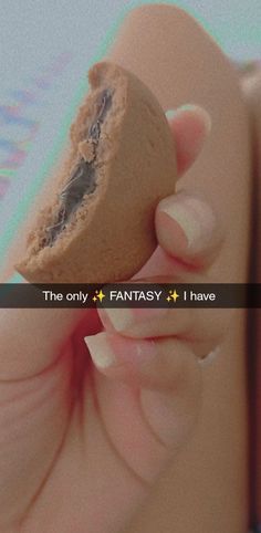 someone holding a cookie in their hand with the caption'the only fantasy i have '